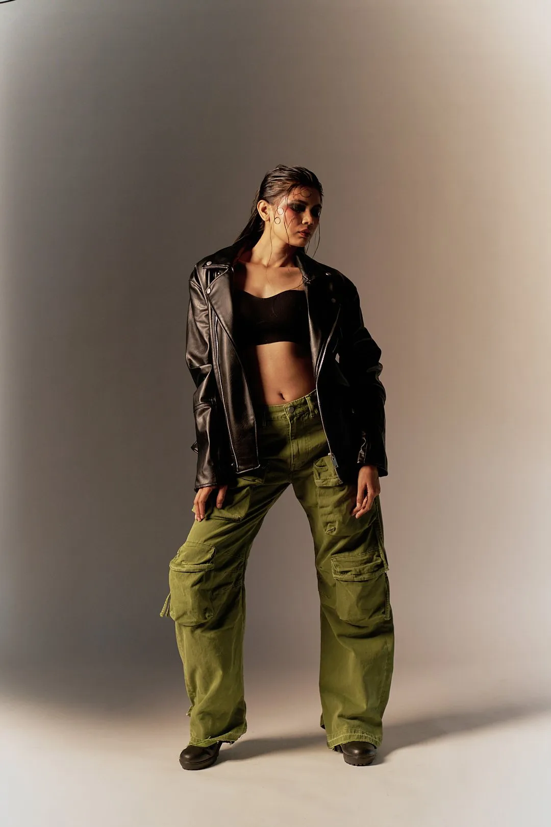 A black leather jacket, green cargo and violet shades on warm grey - one look, four frames.