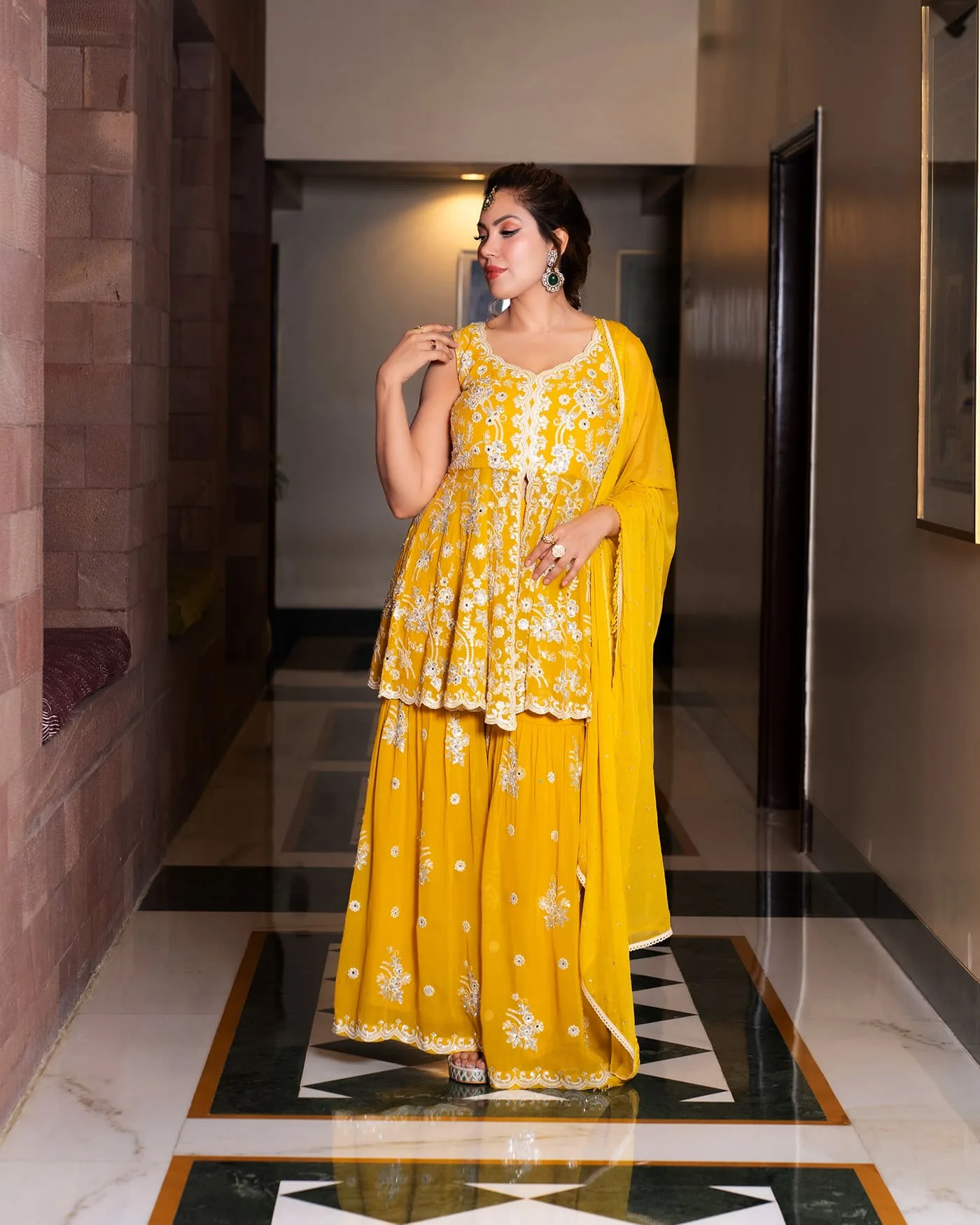A yellow embroidered set shot through hotel corridors, staircases and stone.